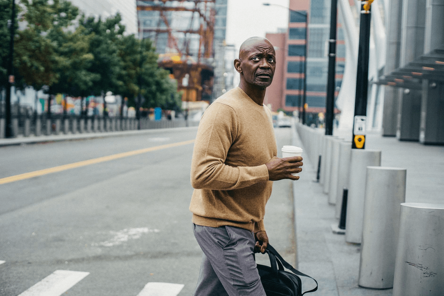 Confident person walking through a city with purpose and ease, natural confident stride, golden morning light representing embodied identity