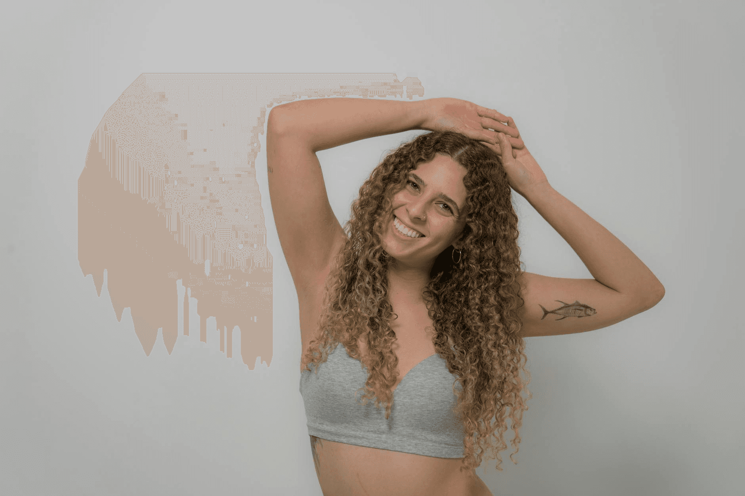 Person in sunlight with arms open and serene expression, representing body acceptance and self-love