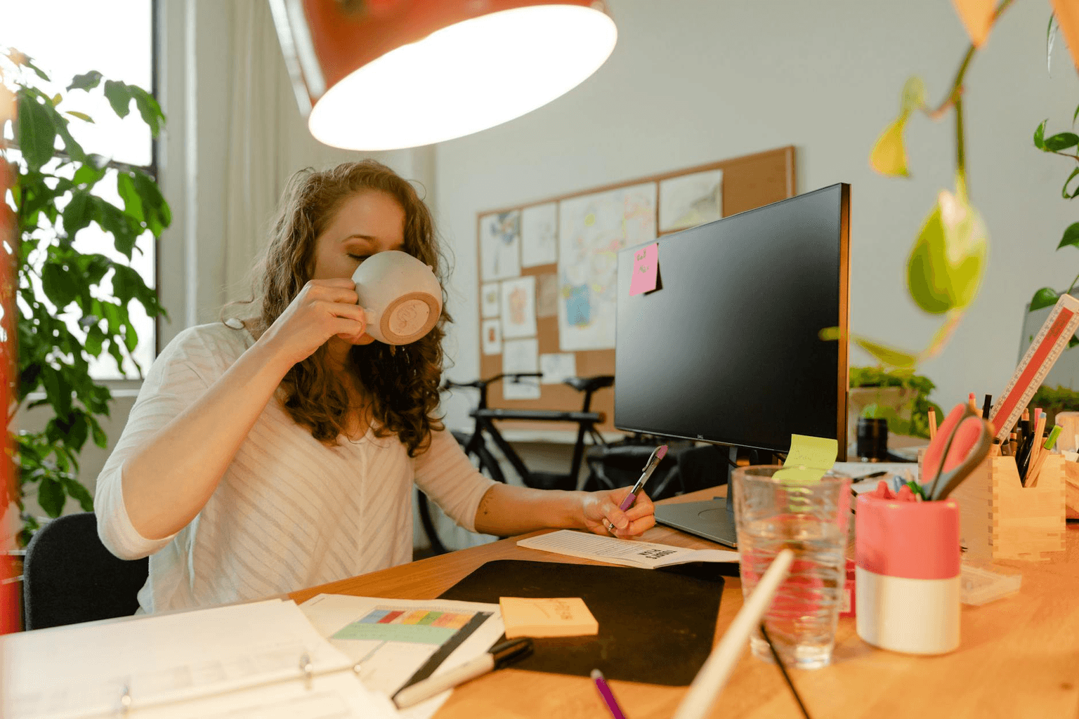 Focused professional at a bright organized desk in morning light, representing workplace confidence and productivity