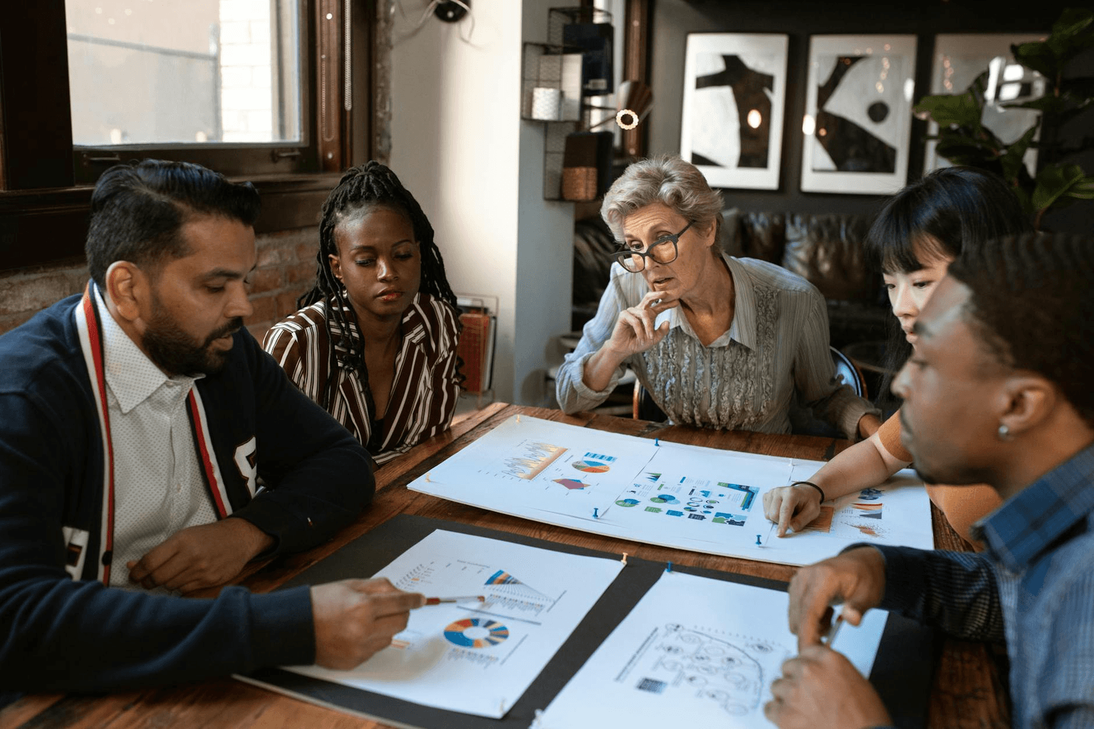 Entrepreneur at a bright desk with charts and golden light, representing business success and abundance mindset
