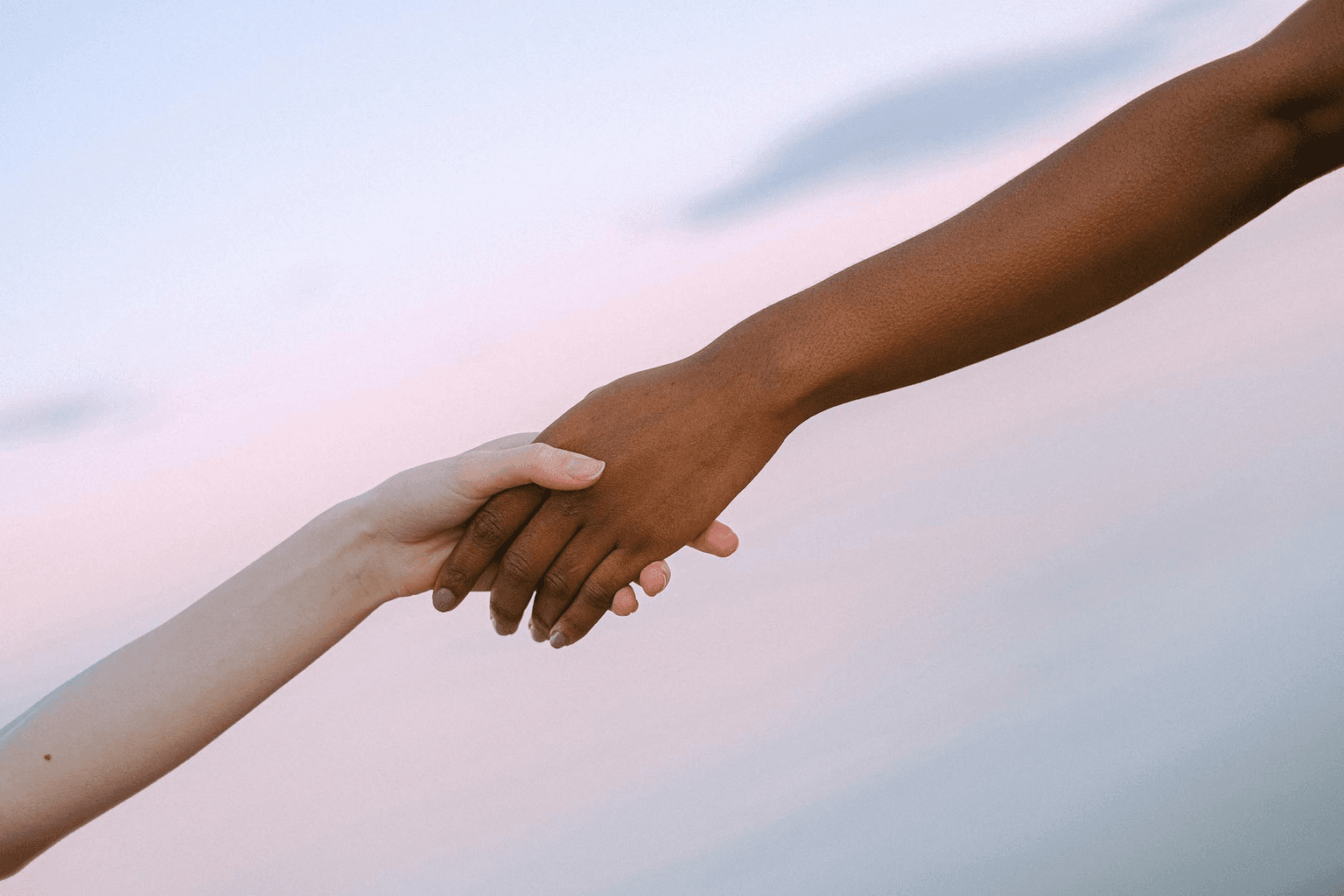 Two people sitting together in peaceful golden light, representing compassion and co-creation