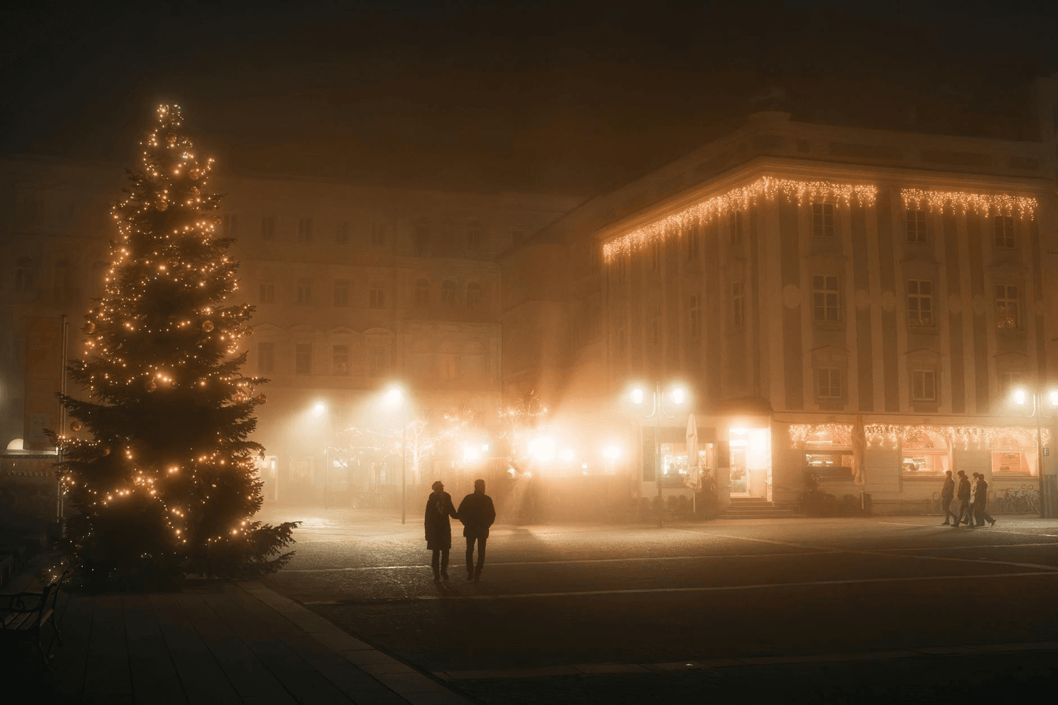 Two people walking together in golden evening light holding hands, representing healthy loving relationship