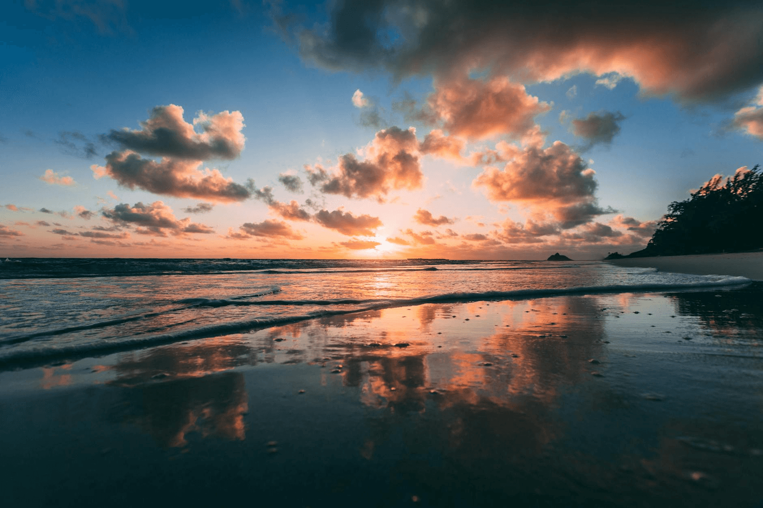 Tropical ocean at golden dawn with soft waves on a peaceful Hawaiian beach representing healing and clearing