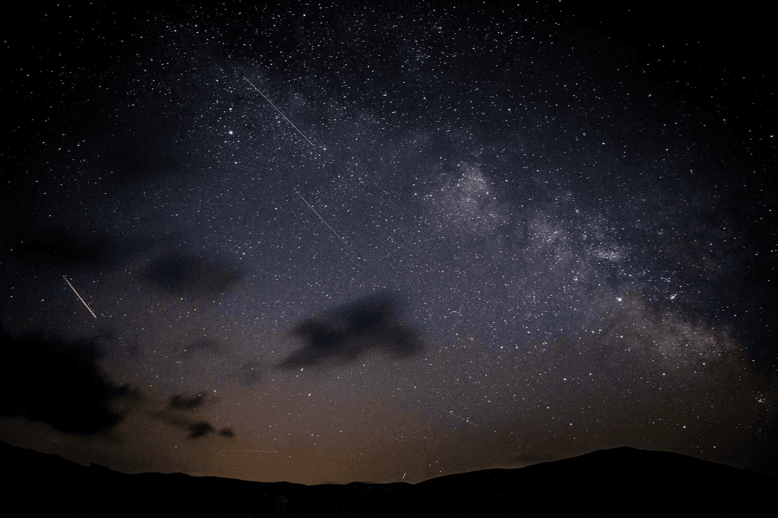 Bright shooting star streaking across a clear night sky representing rapid manifestation and acceleration
