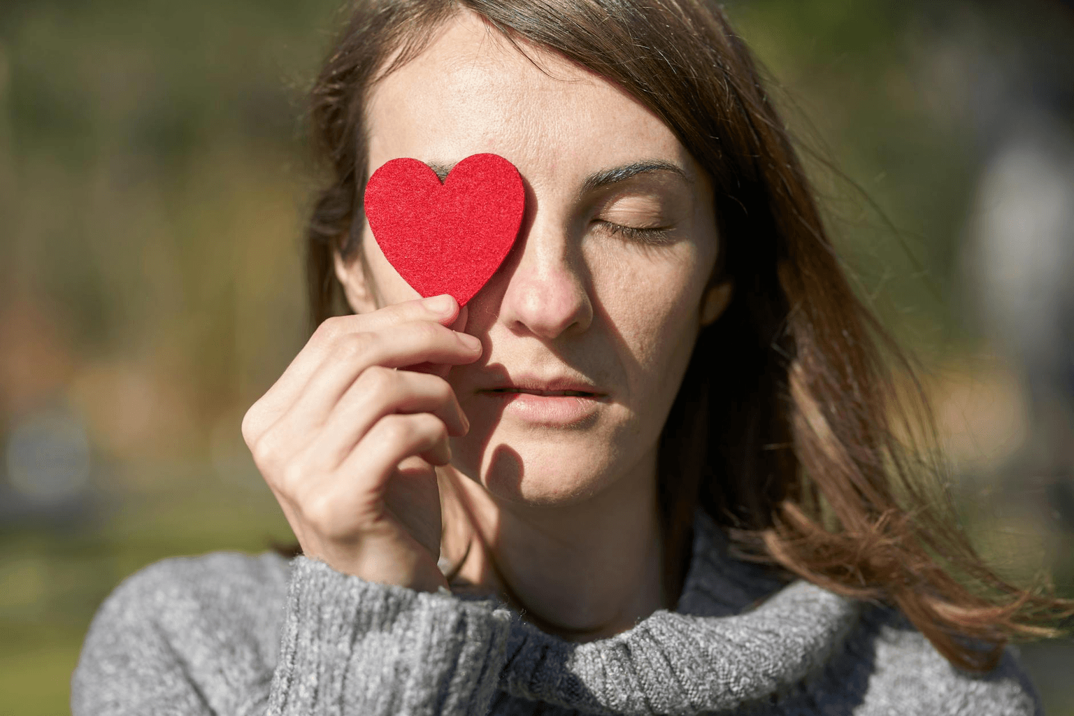 Woman in peaceful meditation with warm golden light, hands over heart, representing self-love and inner acceptance