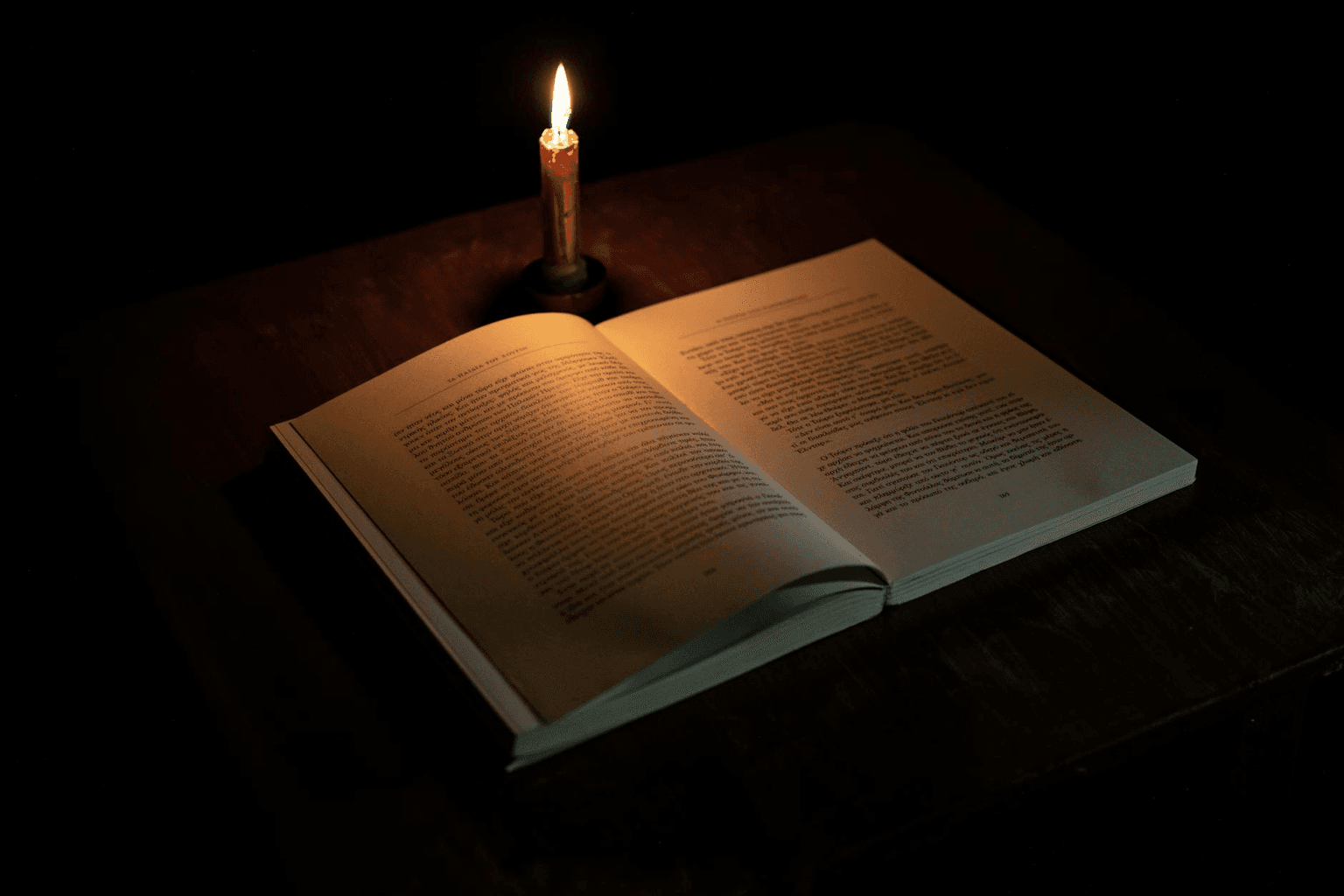 Antique book open to glowing pages in warm candlelight representing Neville Goddard's timeless teachings on consciousness and imagination