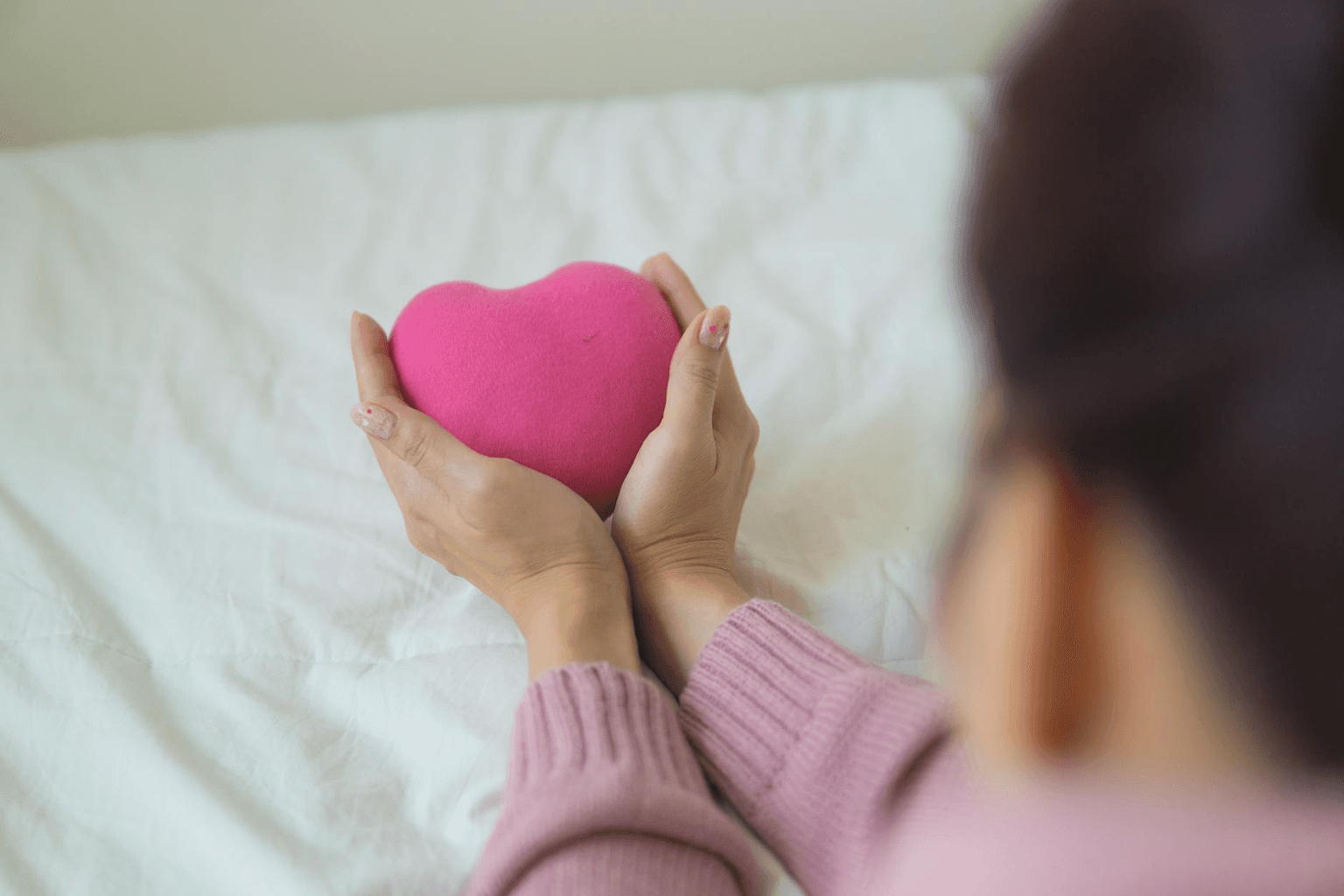 Person standing with quiet confidence in warm morning light, hands over heart