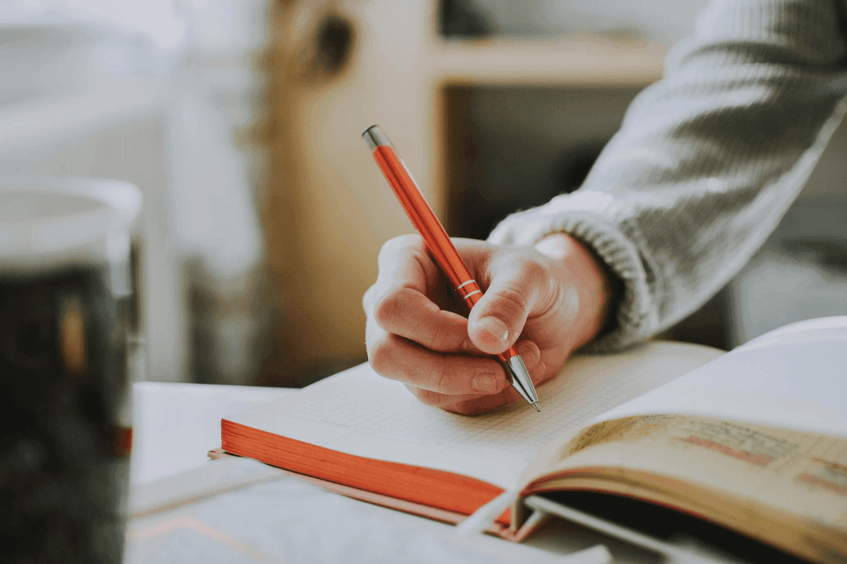 Handwritten manifestation notes beside a small wooden box in warm golden light