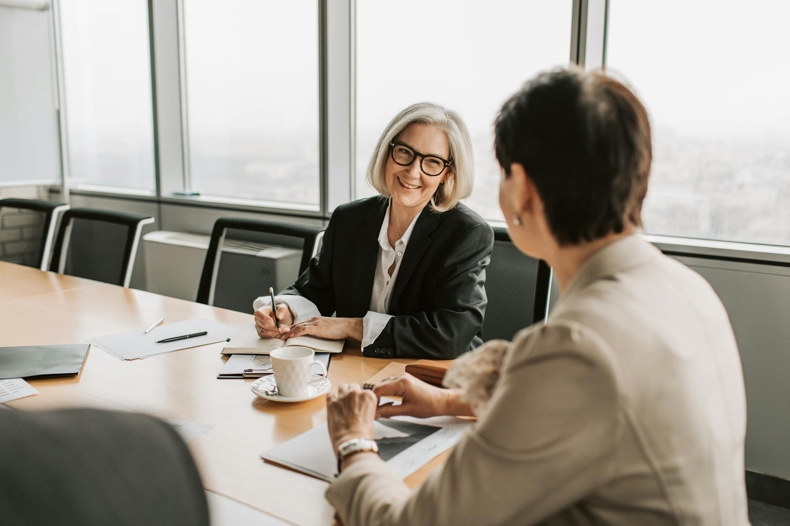 Professional having a confident conversation with manager in a bright modern office